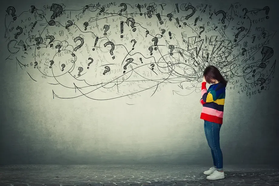 A woman wearing a colorful striped sweater stands with her head down, appearing distressed. A chaotic cloud of question marks, arrows, and scribbles emerges from her head, illustrating confusion and anxiety